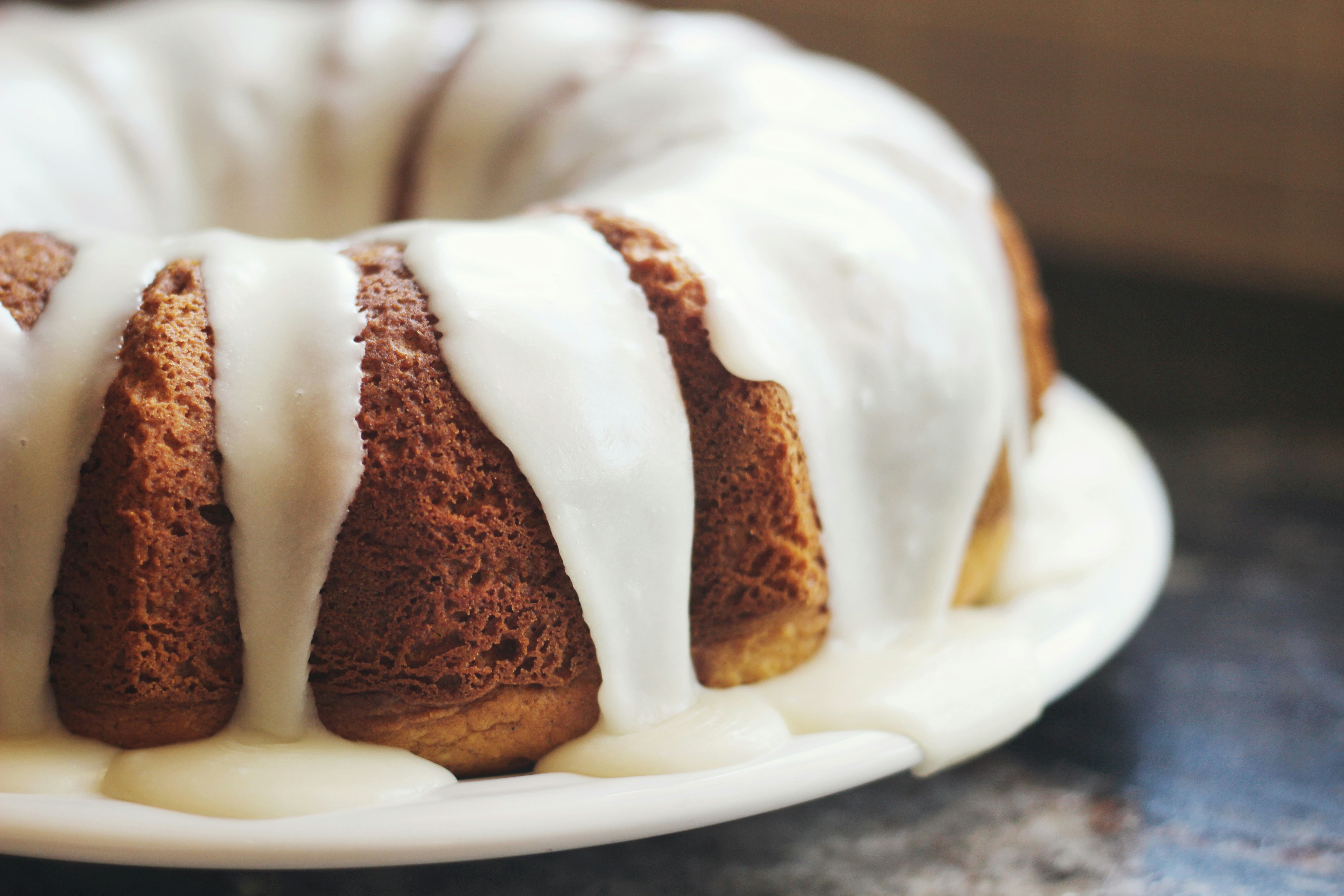 Bundt cake on a plate with white frosting