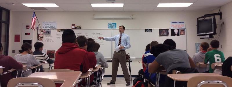 male teacher in front of his class 