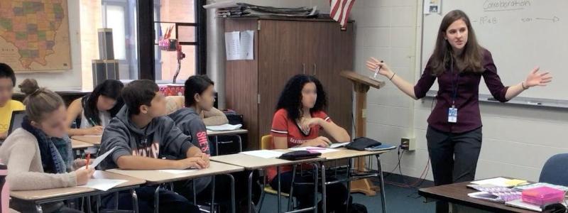 teacher gesturing in classroom