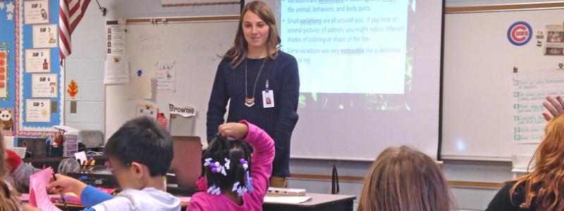 Rachel-in-classroom-with-American-flag