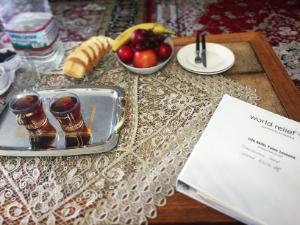 World Relief Tutor Binder on a table with cups of tea, fruit, and water