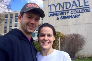 Spencer and spouse standing in front of Tyndale College