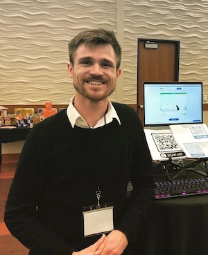 Man in front of computer smiling