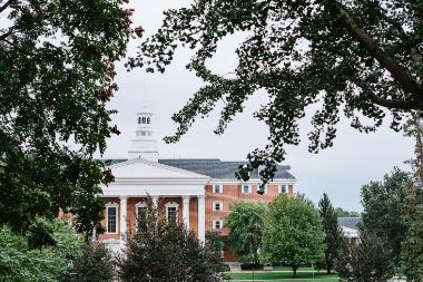 a large brick building surrounded by trees