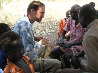 doctor speaking with patients outside