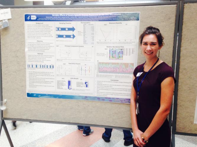 Sarah Mudra standing in front of her poster presentation