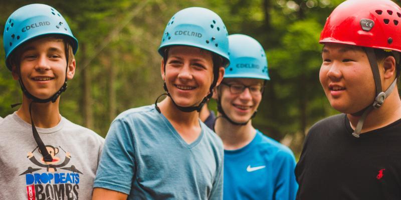 advance camp guys smiling on the challenge course at HoneyRock