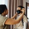 Mom putting mask on child