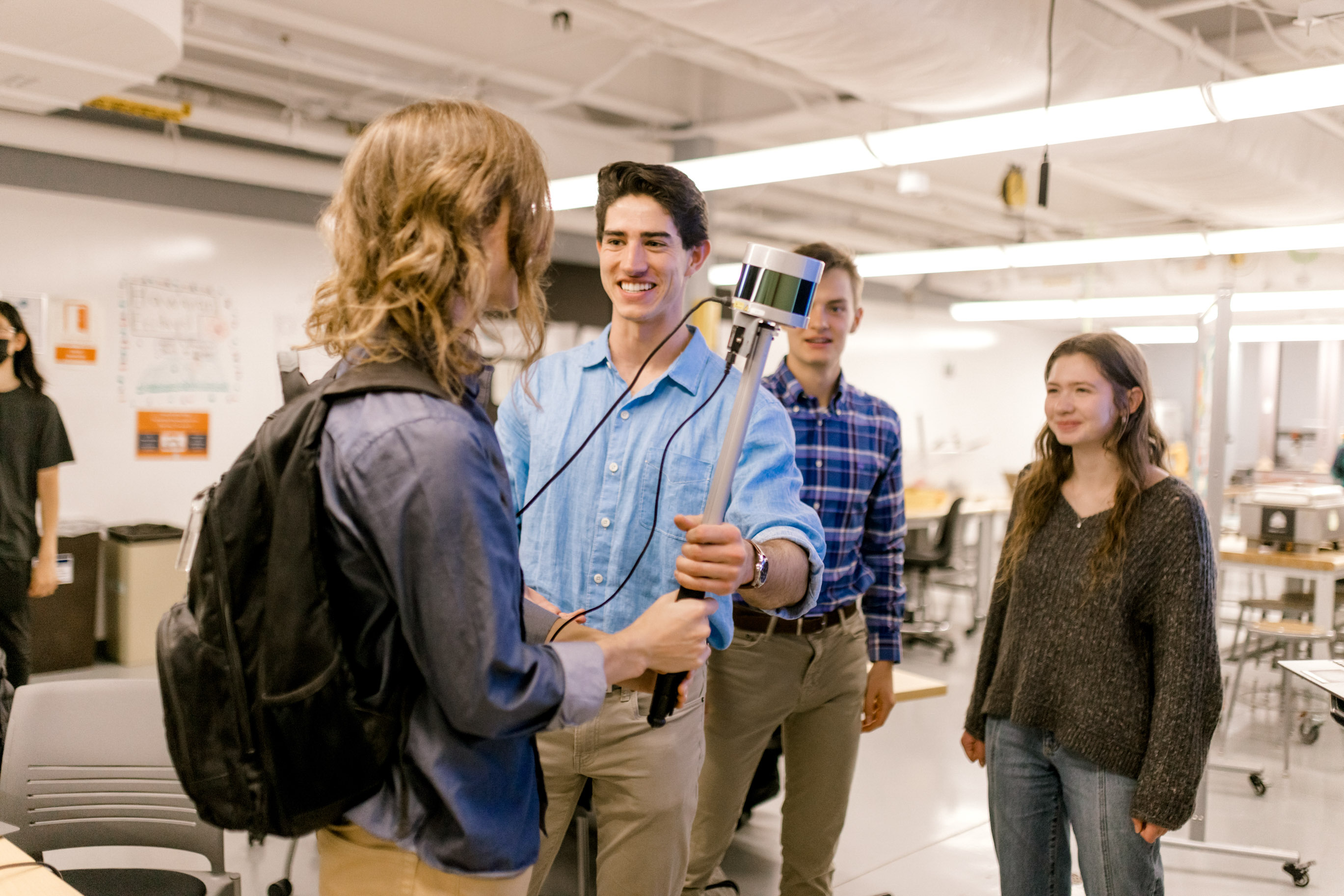 Wheaton College IL four undergraduate engineering majors prepare for a presentation