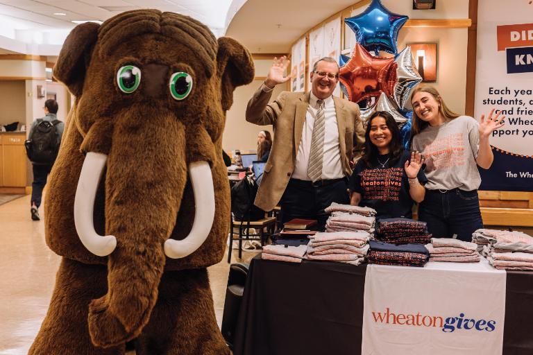 Wheaton College President Philip Ryken and Thunder mascot Tor celebrate WheatonGives