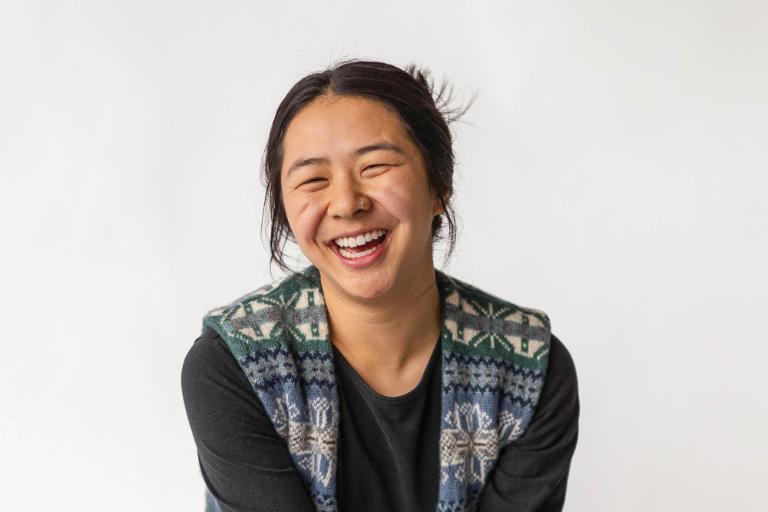 Wheaton College student Ren Chinn sitting and smiling