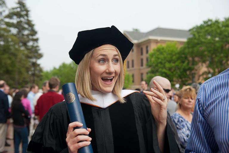 768x512 Laura Shultz holding her diploma with a surprised expression
