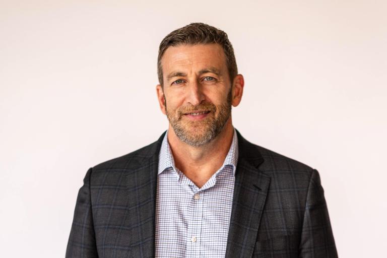 Wheaton College English professor holding books