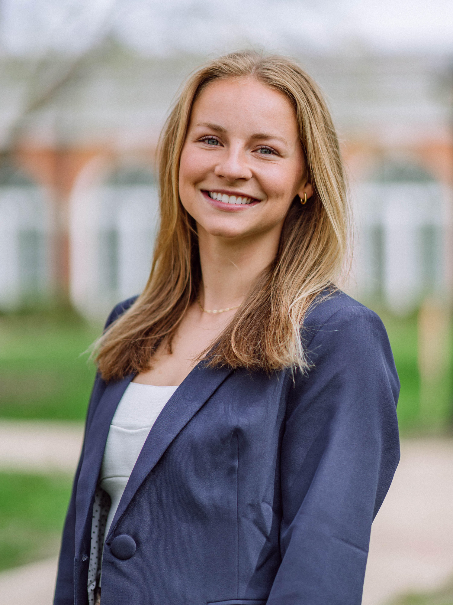 A white blonde young woman smiles