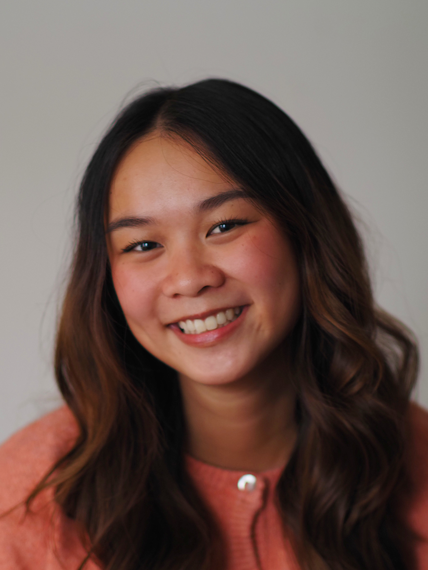 An East Asian young woman smiles