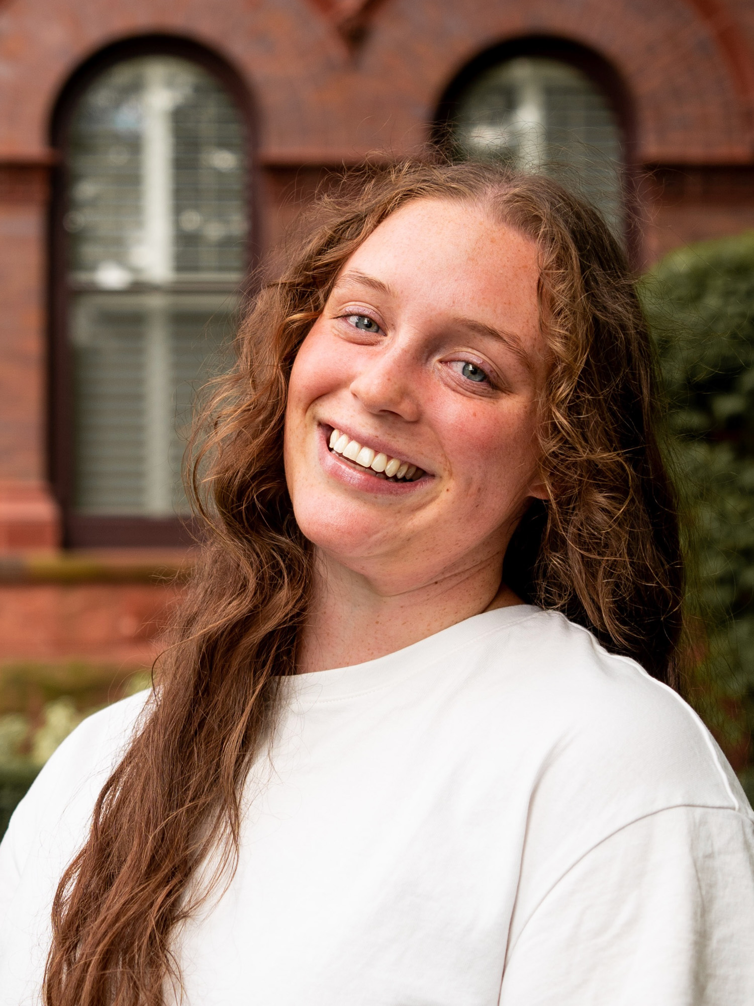 A young white woman smiles