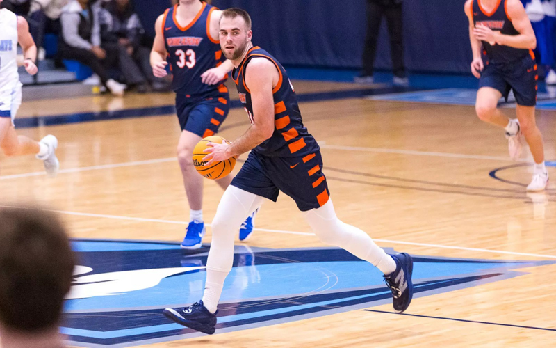 A white brunette young man plays basketball
