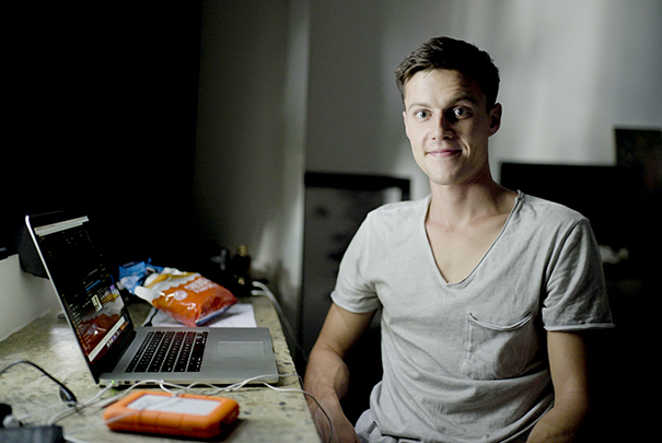 Justin Lovett sitting at desk smiling