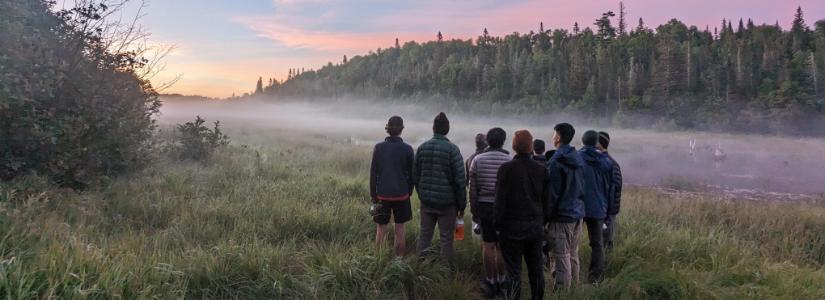 Passage 2023 - Students looking over foggy area 825 x. 300